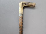 a close up of a wooden stick with a handle on a gray surface
