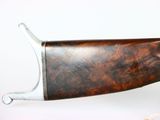 a gun that is sitting on a white surface