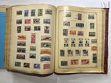 an open book with stamps on it on a table