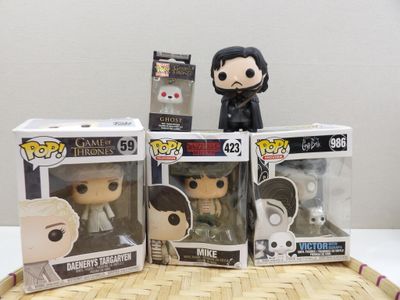 three game of thrones pop vinyl figures sitting on top of a wicker tray