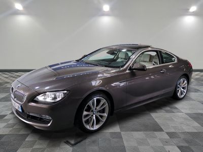 the bmw 6 series grano is parked in a showroom