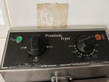 a close up of a fryer with a piece of bread on top of it