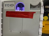 an image of a refrigerator with a red tape on the door