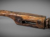 an old wooden pipe cutter on a gray surface