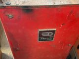 a red metal box sitting on top of a table