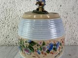 a small figurine sitting on top of a vase