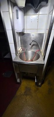 a sink that is in the corner of a room