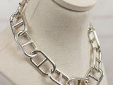 a close up of a necklace on a mannequin on a table