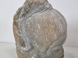 sculpture of a woman ' s head on a white surface