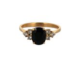 a close up of a gold ring with a black stone
