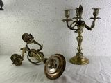 two brass candlesticks sitting on a white table