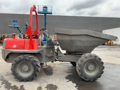 a red dump truck parked in front of a building