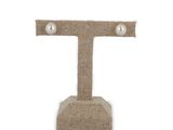 the letter t is made out of burlock with pearls on it