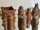 a lot of vases that are sitting on a glass table