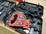 a black and red tool in a case on a table