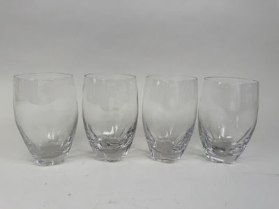 quatre verres vides sont alignés sur une surface blanche