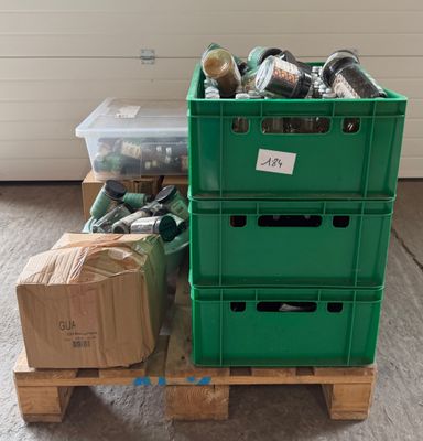 a green crate sitting on top of a pallet next to a stack of boxes