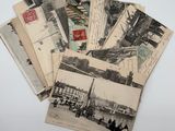 a pile of old postcards sitting on top of a table