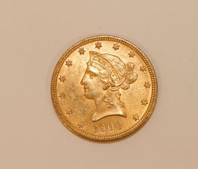 a close up of a gold coin with a woman ' s head on it
