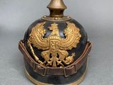 a black and gold helmet with a gold eagle on it