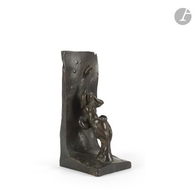 statue of a man and a dog on a bookend