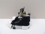 a pair of black and white sneakers on a white surface
