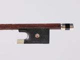 a close up of a violin bow on a white surface