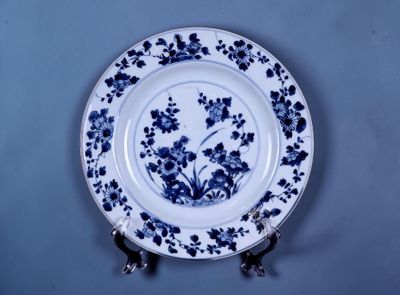 une assiette bleue et blanche ornée d'un motif floral
