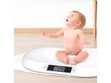 a baby that is sitting on a scale on the floor
