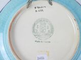 a blue and white plate with a seal on it
