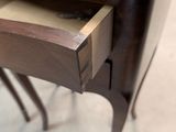 a small drawer that is open on the side of a table