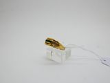 a gold ring sitting on top of a clear box