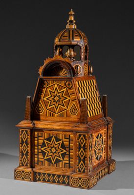 an old wooden clock with a star design on the front