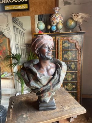 a bust of a woman sitting on a table in a room