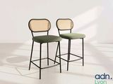 pair of black and green bar stools against a white wall