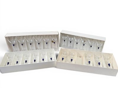 four wine glasses in a white box on a white surface