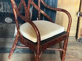 a chair with a cushion on it in front of a fire place