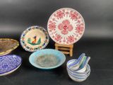 many plates and bowls sitting on a black surface