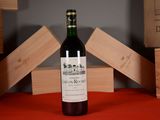 a bottle of wine sitting on a table next to wooden blocks
