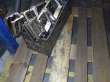 several cell phones are sitting in a metal case on a pallet