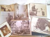 many old photos of people sitting on a table