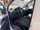 a white van with its door open in a parking lot