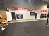 a picture of a gym with a bench and a barbell