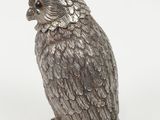 silver owl figurine on white background with white background