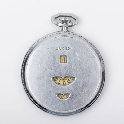a silver pocket watch with a heart on it