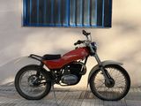 a red motorcycle parked in front of a white building