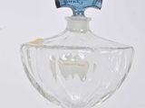a clear glass bottle with a blue label on it