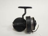 a close up of a fishing reel on a white surface