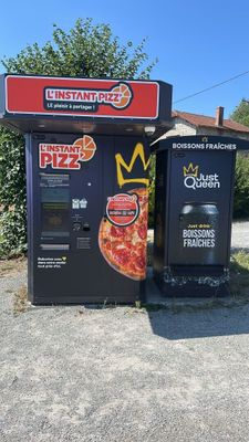 two vending machines sitting next to each other on the side of the road