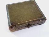 a small wooden box with a lid on a white surface